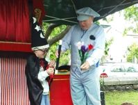 Martin performing an outdoor Punch and Judy show